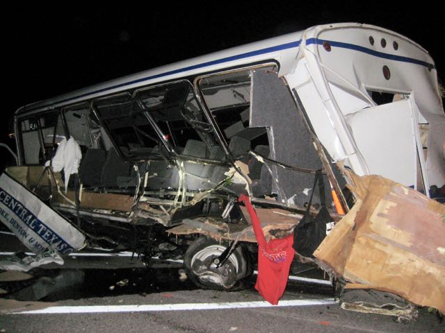 A Champion Defender Bus in which 4 women softball players from North Texas Central College were killed on September 26, 2014 is pictured at the accident scene. Personal Injury Lawyer Todd Tracy of Dallas is suing Champion Bus for an unsafe design that failed to keep the women from being ejected.