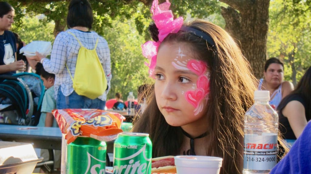 Student Shows Off Her Painted Face At School Carnival Sponsored by Vehicle Safety Lawyer Todd Tracy for Medano Elementary in Dallas