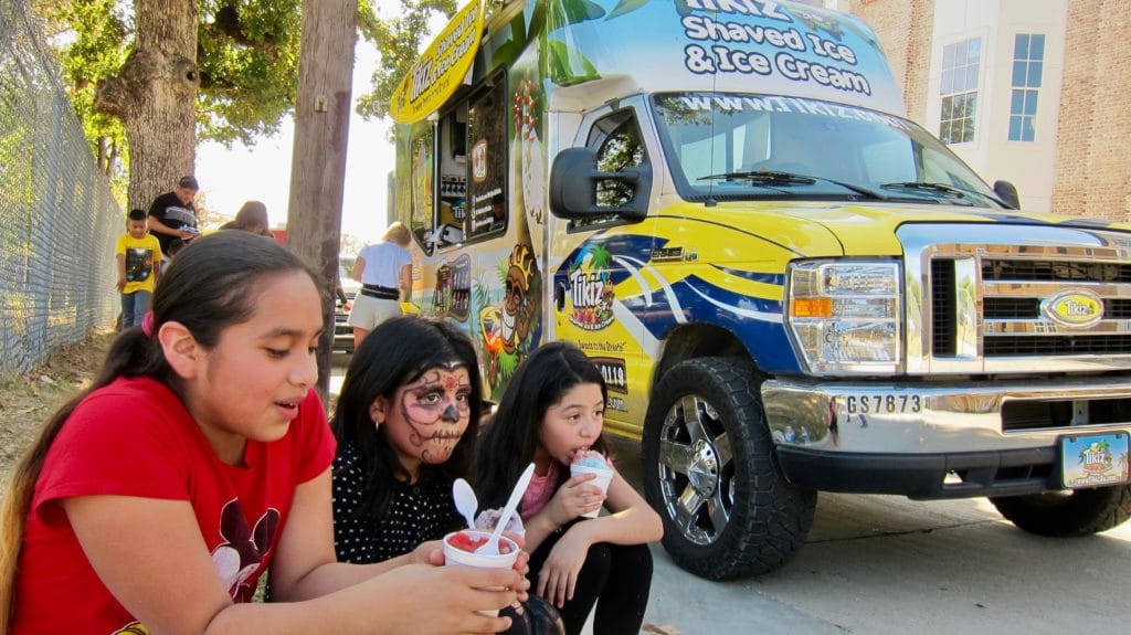 Students Enjoy Ice Cream from Food Trucks Donated by Vehicle Safety Lawyer Todd Tracy for Medano Elementary School Carnival in Dallas